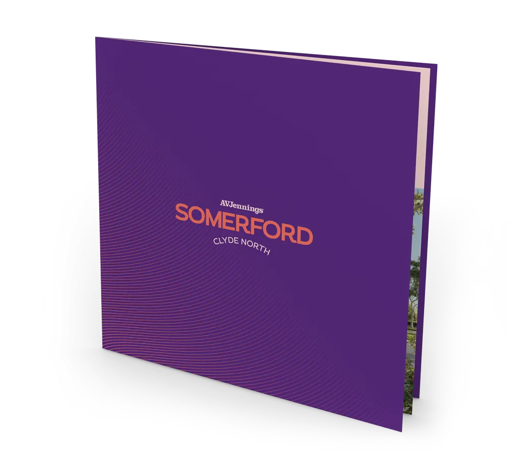 A purple square booklet titled “Somerford Clyde North” with the AVJennings logo, standing upright and slightly open, revealing colorful pages inside.